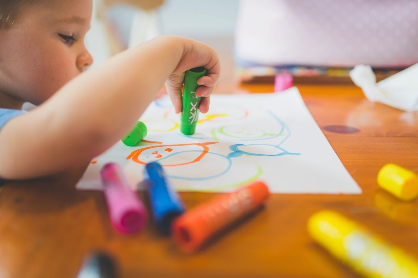 Child Drawing With Colored Pencils