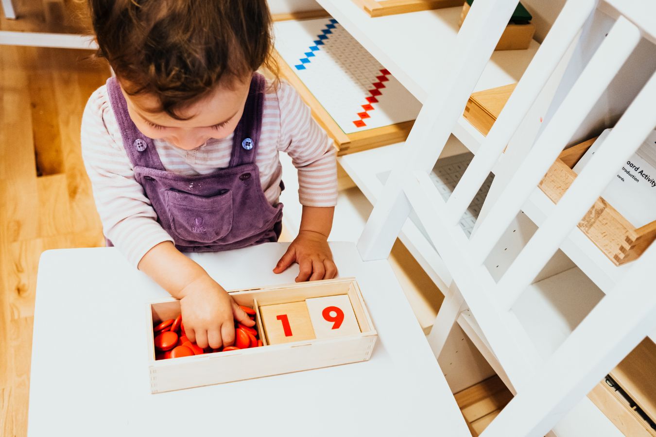 toddler learning numbers with montessori materials