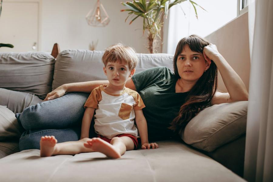 Parent and young child sitting together on a sofa