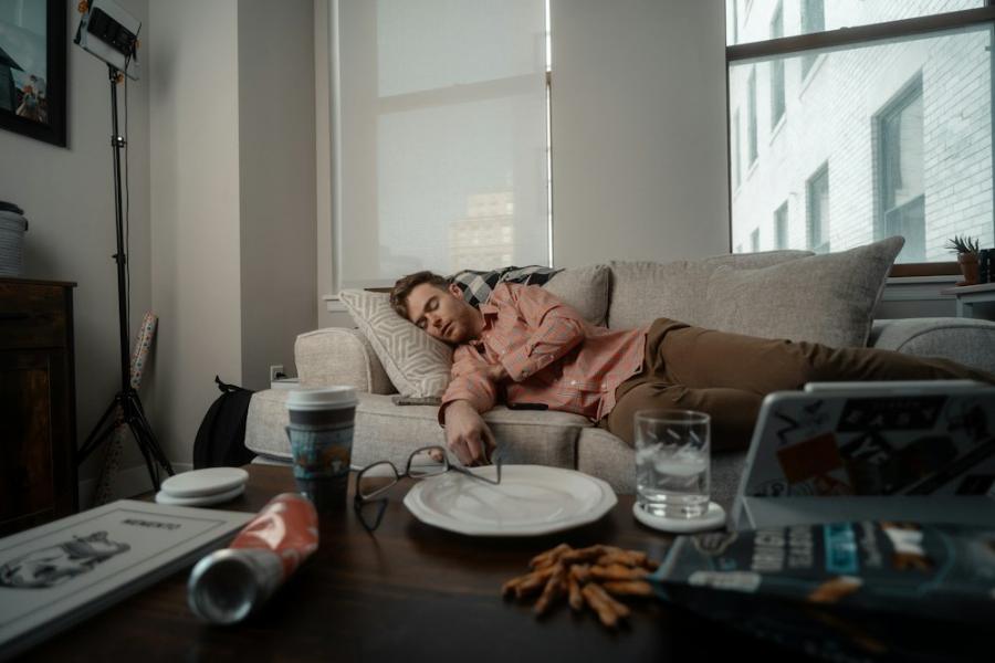Tired parent lying on a sofa