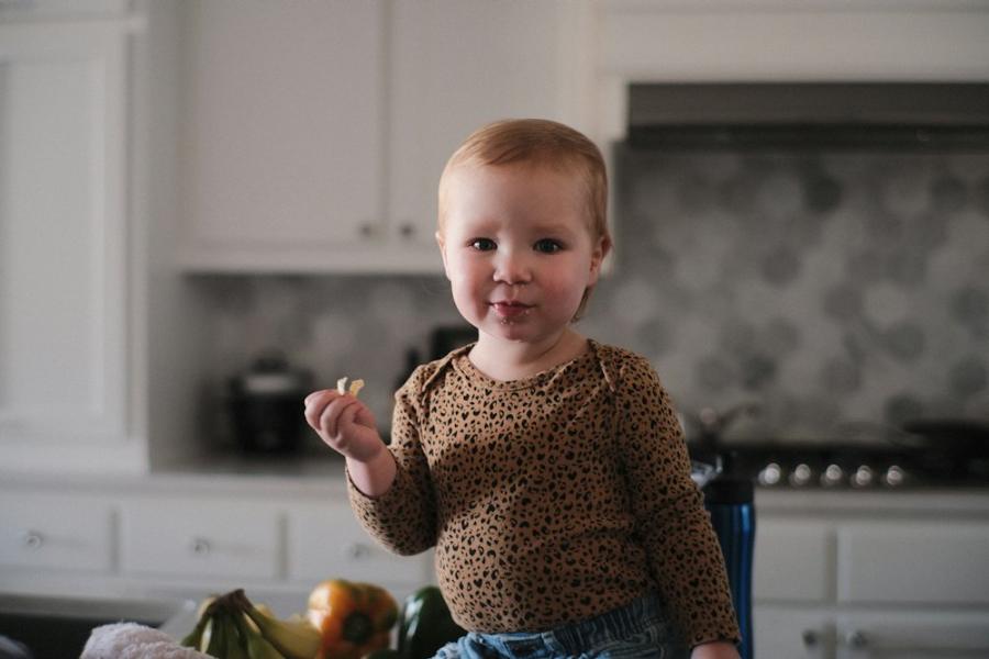Toddler standing in a home kitchen