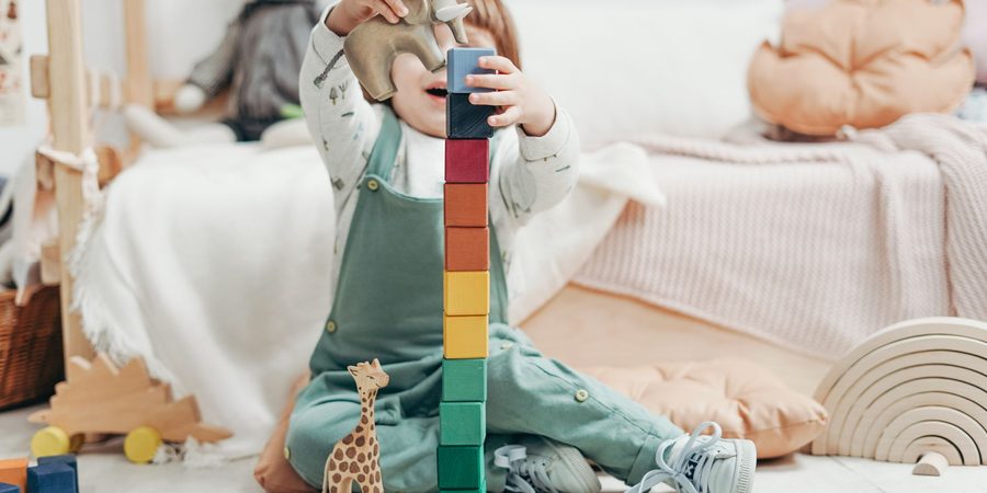 Toddler playing with wooden toys at home