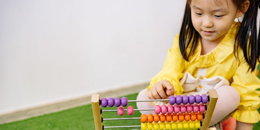 Girl counting beads on an abacus
