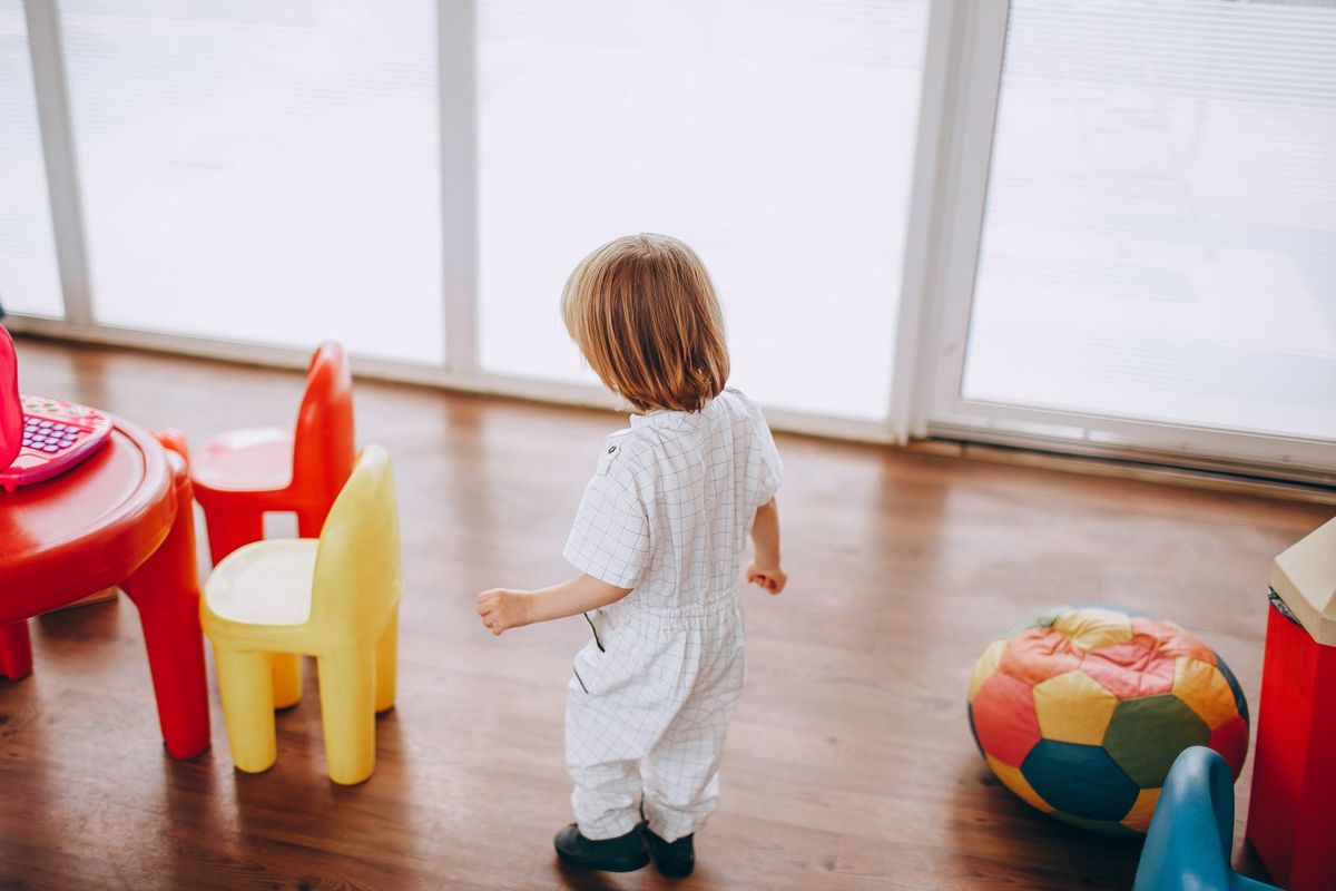 Toddler walking toward small child-sized chairs